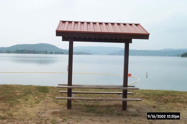 Photo P-11. Covered table. Starkey Park, Beaver Lake, AR. Shade structure constructed to provide shade for table (Table 5.13).