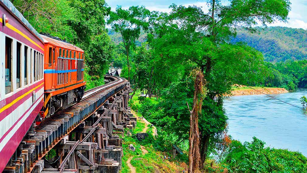 State Railway of Thailand Tour Packages 109 Train No. 258 on Tham Krasae Trestle along the Kwai River on the "Death Railway" constructed during World War II.
