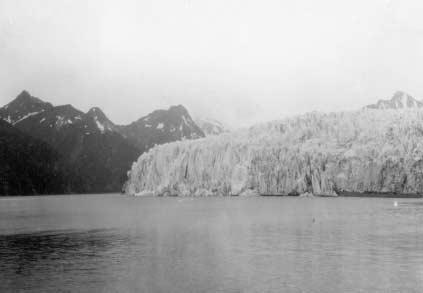 The 1919 photograph (left) shows the then retreating, debris-covered terminus of East Fork Teklanika Glacier with an elevated lateral moraine on its west (left) side.