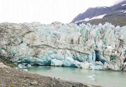 September 2003. The left-hand photograph shows the calving terminus of Lamplugh Glacier extending to within a half mile of the photo point. No vegetation is visible.