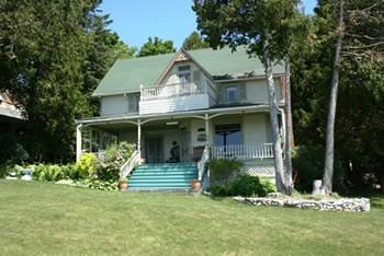 Listing courtesy of Mackinac Island Realty Offered at $270,000 East Bluff 6844 Huron Road-This cottage has "million dollar" views of the Mackinac Island Harbor and