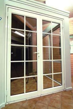 A pivot door rotates on two metal pivots at the top and bottom