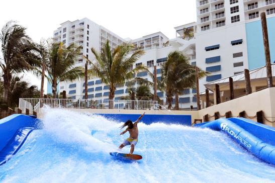 FlowRider Double - a surf simulator generates a thin sheet of water which flows over a