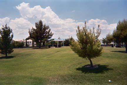 The site features a large play area, including swings, four covered picnic pads, and a running track that is approximately a quarter mile in length.