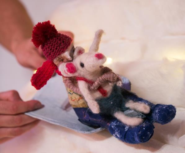 For a little while the child cannot find Snow Mouse. The child gets out a torch and searches and calls for Snow Mouse.