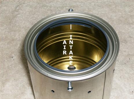 Put the stove together by sliding the 1 quart paint can over the 27 ounce food can, lining up the seams in both cans.