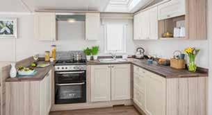 The kitchen with its Shaker style soft close doors includes a microwave and fridge freezer so