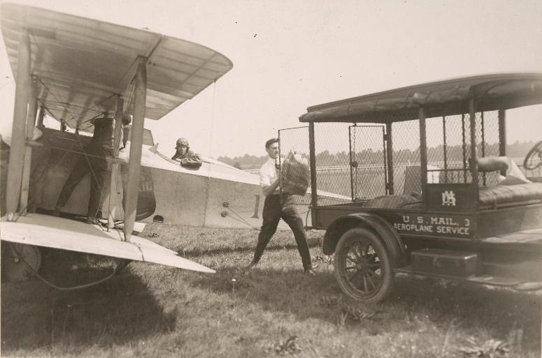 right of Miller), Postmaster William Carlile (holding his hat near front center), and pioneering aviator Augustus Post, secretary of the Aero Club of America (bearded, at far right).