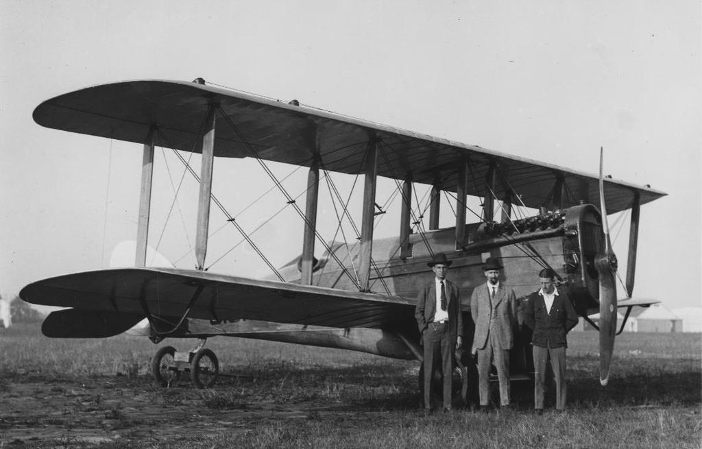 Airplane engineer, airmail official, and airmail pilot, circa 1922. From left to right: Paul G. Zimmermann, aeronautical engineer who helped developed high lift wings for heavier mail loads; John E.