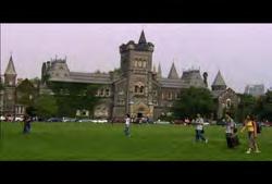 Toronto: Static shot of students walking across campus field with Knox College in