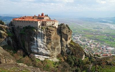 After breakfast, travel to Meteora located in Thessaly plains, massive gray colored rocks rise towards the sky and monasteries perched on top of enormous rocks.