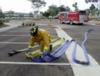 To pull hose, place nozzle over fire-side shoulder and pick up loops and advance towards