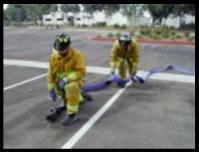 Firefighter #1 commands ADVANCE HOSE. Firefighters proceed to objective.