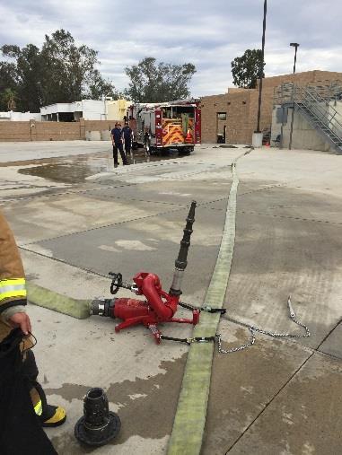 Connect straps loosely around hose parallel to center leg. Retrieve the deck gun and place it on the base. Engage the lock pins.