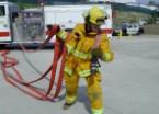 Yell HOSE and proceed away from apparatus. Keep loops separated by exaggerating arm position.