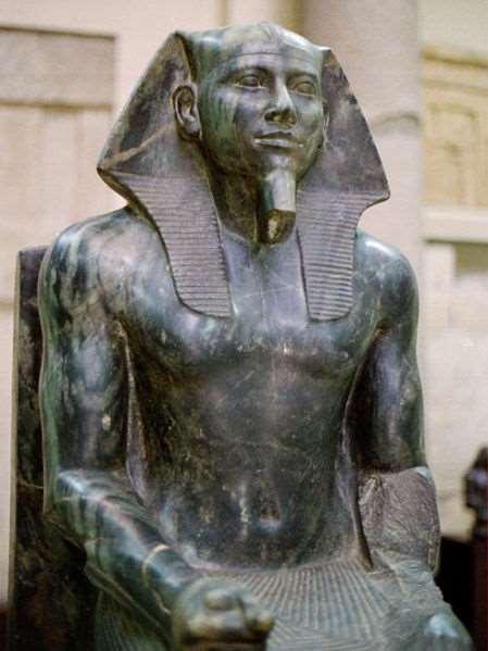 Khafre wears the royal fake beard fastened to his chin and wears the royal linen nemes royal headdress worn by the pharaoh containing the cobra of kingship on the front Found in a Valley Temple A