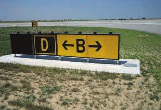Figure 14-18. Taxiway Bravo direction sign with a collocated Taxiway Delta location sign. When the arrow on the direction sign indicates a turn, the sign is located prior to the intersection.