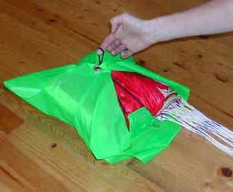 25 Place the canopy onto the bag and thread the elastic string through the