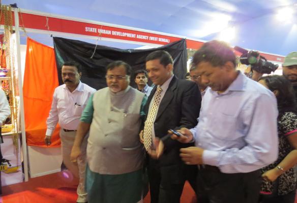 Visit of Mr. Partho Chatterjee, Hon. Minister for Industries & Commerce, Government of West Bengal to Kerala Pavilion; flanked by Shri. Suraj S., Manager, K-BIP.