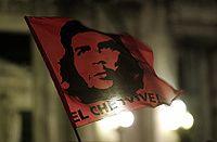Dr. Peter McLaren, author of Che Guevara, Paulo Freire, and the Pedagogy of Revolution [173] A stylized graphic of Guevara's face on a flag above the words "El Che Vive" (The Che Lives).