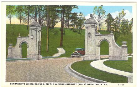 This postcard shows an auto exiting the stately entrance to Wheeling Park on the National Road.