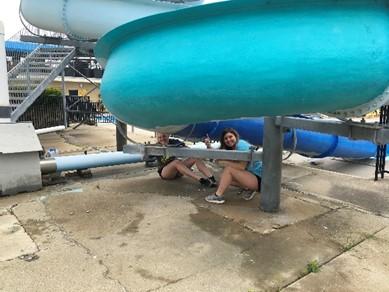 painting the outdoor pool waterslide a royal blue. The ladies started at the bottom and the guys at the top.