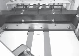 Remove the left and right side covers. 6. Remove the four screws and nuts holding the top infeed table's conveyor bracket to the infeed table. (Fig 25) 7.