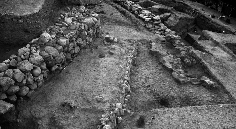 rubble fillings bordering the street parallel to the main stone wall, from east; to the right, massive stone corner called Wall W.5. Fig. 11.