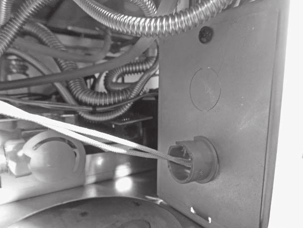 5. From inside the control compartment, punch out one of two available knockouts located in the electrical connection