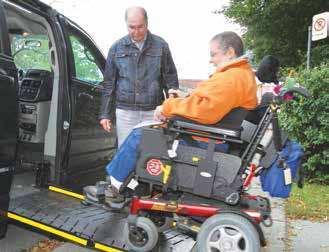 Service user boarding an adapted taxi. Driver assisting a client.