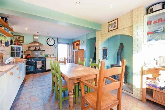 The sitting room is L shaped and has French doors which open out to the rear patio and garden. There is a wood burning stove set on a stone base and beautiful flooring throughout.