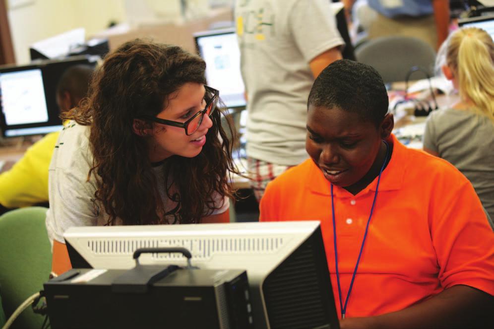 Teaching assistant and William & Mary student Sophie Berman, left, assists a camper.