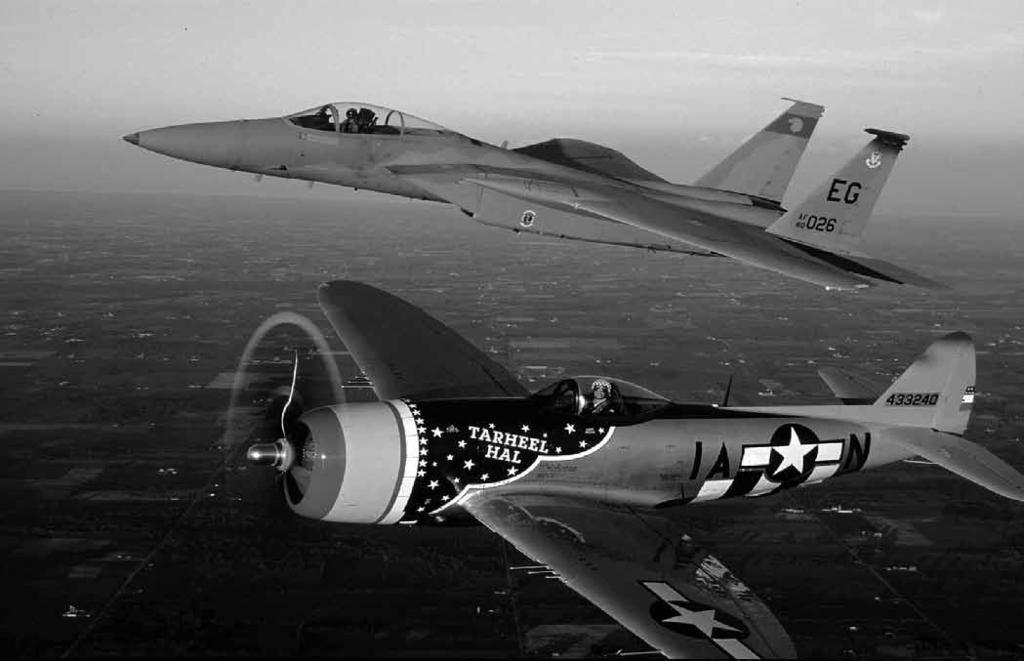 In the background is a Korean War era F-86 wearing a patriotic paint scheme.