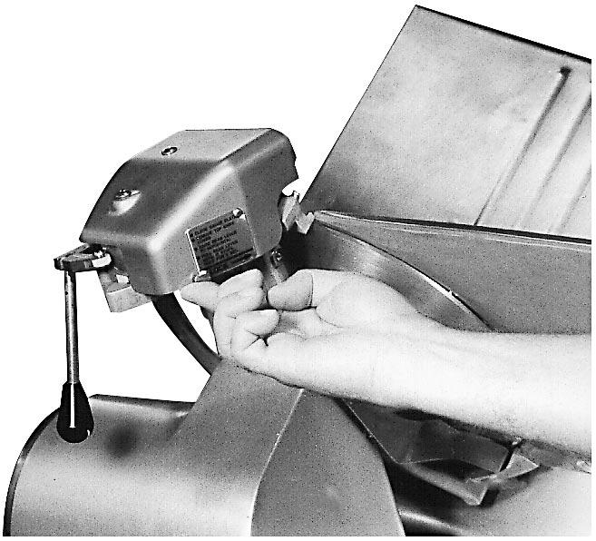 To reassemble sharpener, place sharpener into position on the bracket, lift front of sharpener slightly, and slide back so that rear slot on sharpener slides over rear guide pin on bracket (Fig's.