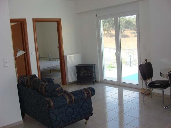 living area also with French doors leading to a terrace. The kitchen has floor cupboards with all appliances and the house is fully furnished. The property comes fully tiled (incl.