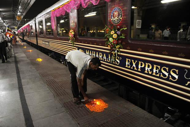 LUXURY: A railway worker lights a candle in preparation for flagging off the Maharajas' Express My personal butler yes, this is one hell of a train showed me to my en-suite cabin and we set off on