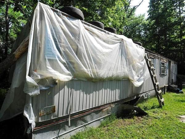 Plastic sheeting covers the house.
