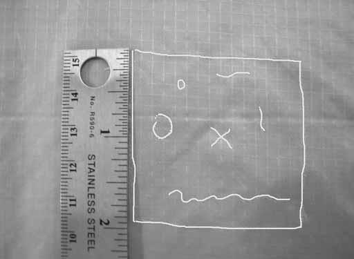 Find the center of the damage and mark it with an X. Allow approximately 2 inches from each boundary side for repair work. This includes a 1- inch seam allowance.