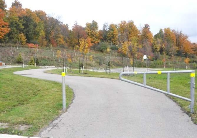 b) Provide a bollard gate for trails or pathways abutting sidewalks, roadways, areas of potential vehicular access and major trail intersections.