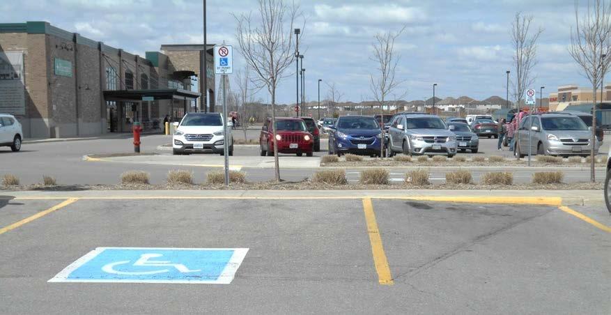 6.0 GLOSSARY Access Aisle: part of an accessible parking space used to provide room for people to enter and exit their vehicles.