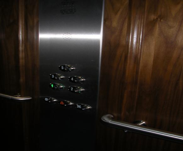 The lifts have a mirror on the back wall. On the right as you enter are the operating buttons and emergency panel.