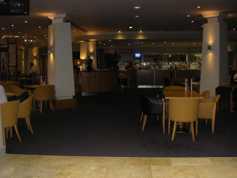 Both the restaurant and bar area are carpeted. The restaurant also has a wooden, varnished floor in some areas and a tiled floor in other areas.