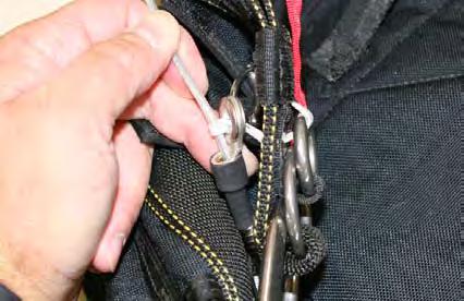 3.3.6. Continue threading the locking loop through the grommet on the end of the cable housing.