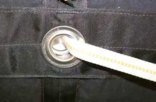 3.4.31. Ensure that the two grommets line up and that no fabric is trapped between the grommets.