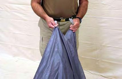 3.5.6. Flaking and Folding the Main Parachute In one hand gather all the packing tabs located on the parachute top surface. Begin with the tabs located near the trailing edge.