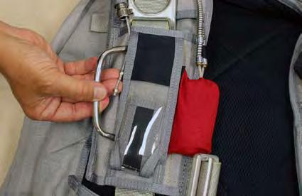 3.6.3. Secure the main ripcord handle in the ripcord pocket. Ensure that the handle is fully inserted into the pocket.