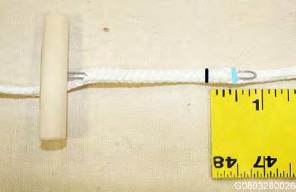 2.3.9. Insert the finger-trapping tool into the line at a distance greater than the amount of line being finger-trapped. The finger-trap tool should emerge at the ½ mark drawn in the previous step.