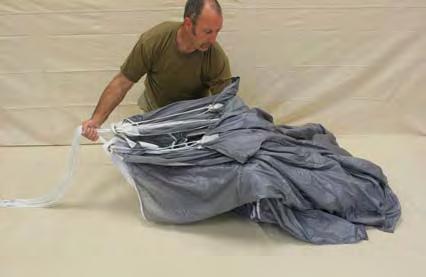 Place all line groups in one hand and place the other mid way down the parachute to support the fabric.