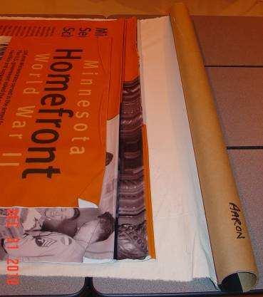 DISASSEMBLY INSTRUCTIONS (CONTINUED) STEP 2-C: Rolling and Packing the Fabric Graphic Panels With a partner, carefully roll the fabric graphic panels up on the cardboard tube, smoothing the wrinkles