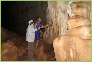 You reach this cave by taking a bamboo raft and then hiking a short distance up the side of the cave structure.
